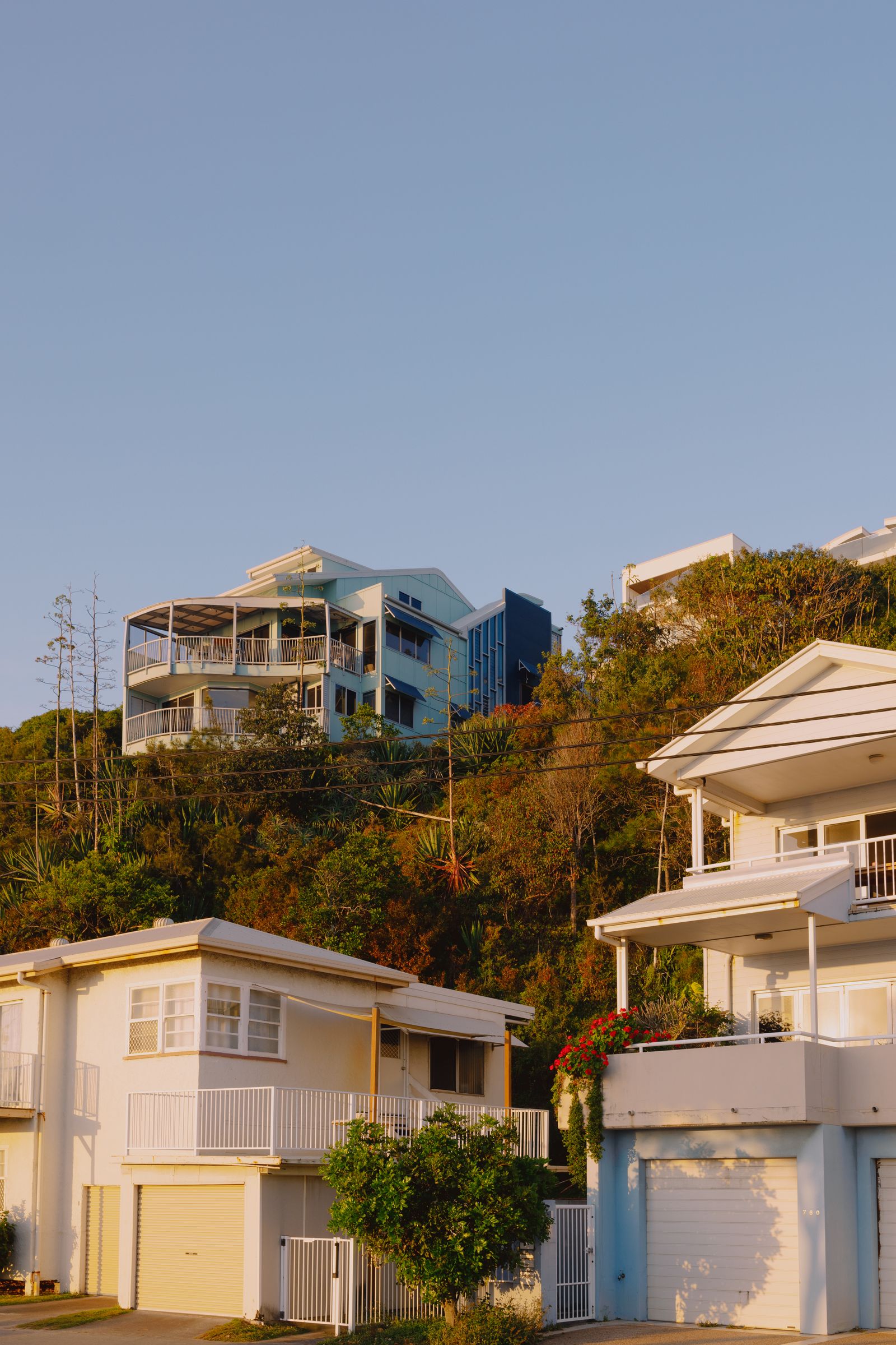 Queensland coastal homes on a hillside at sunset